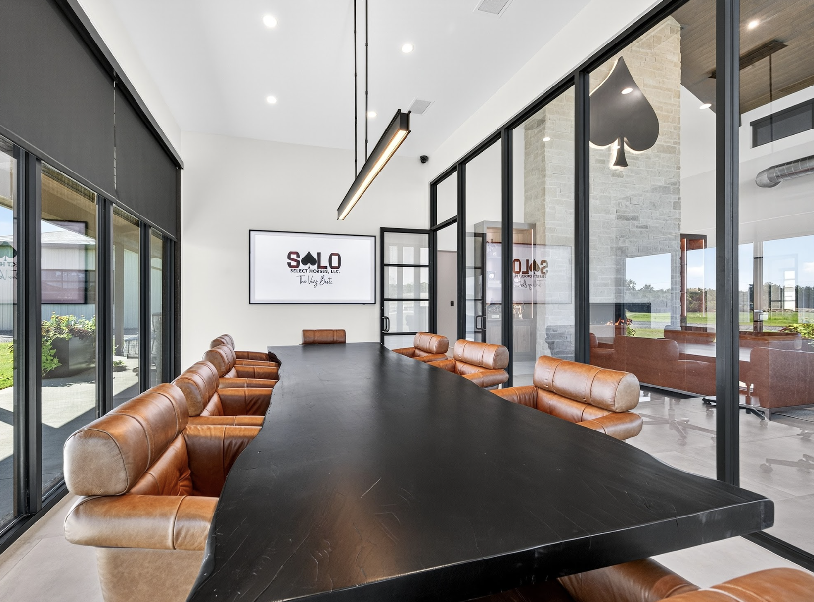 The boardroom, with the SOLO wordmark on screen and the lounge beyond