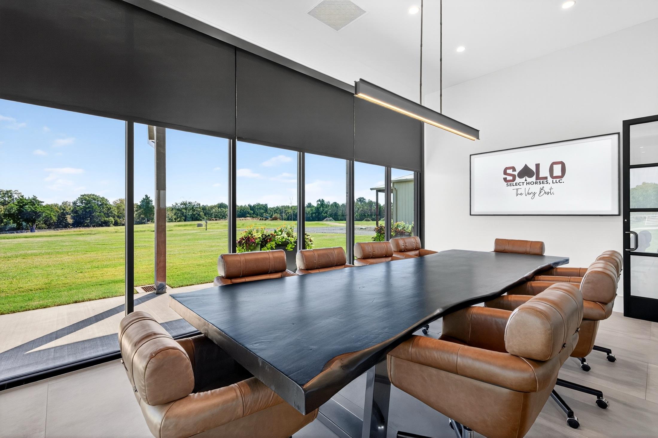 The conference room's wall of windows over the pasture