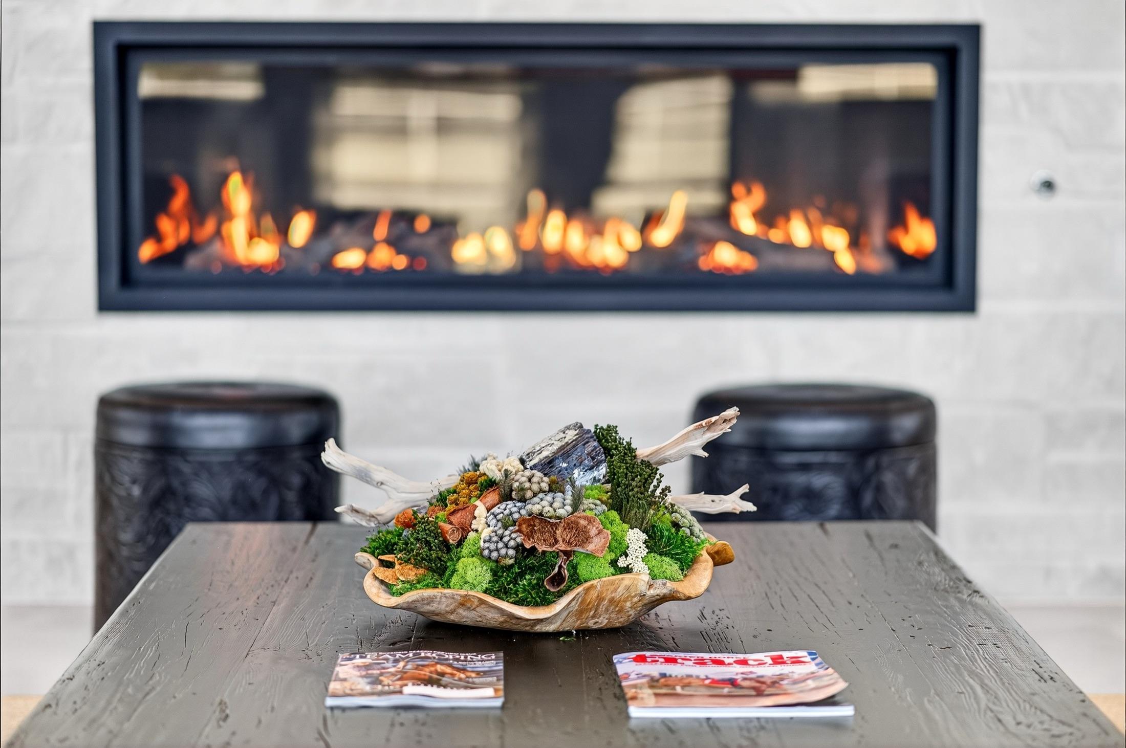 A natural centerpiece on the lounge table, fireplace behind