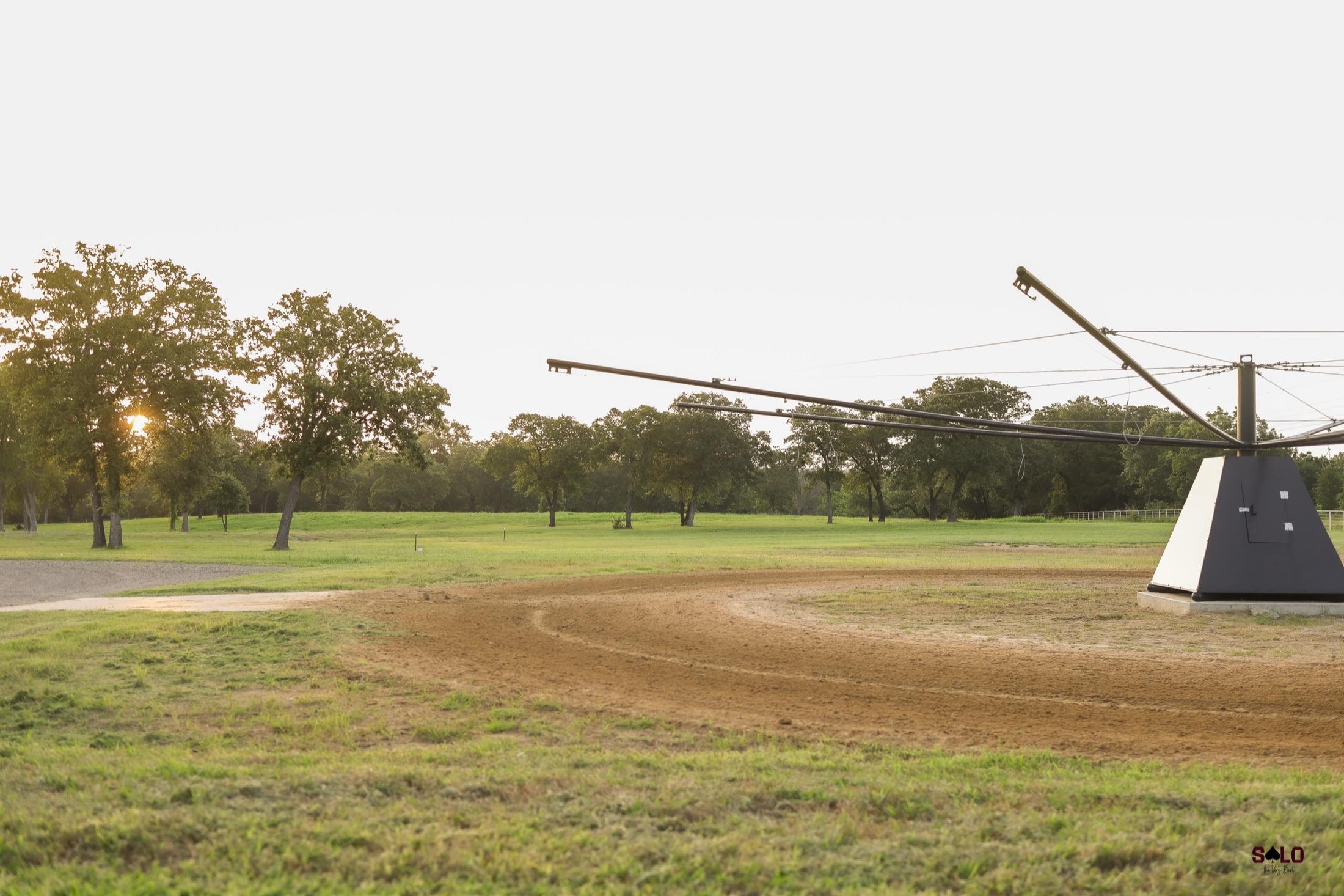 The automatic walker and worked ground at sunset