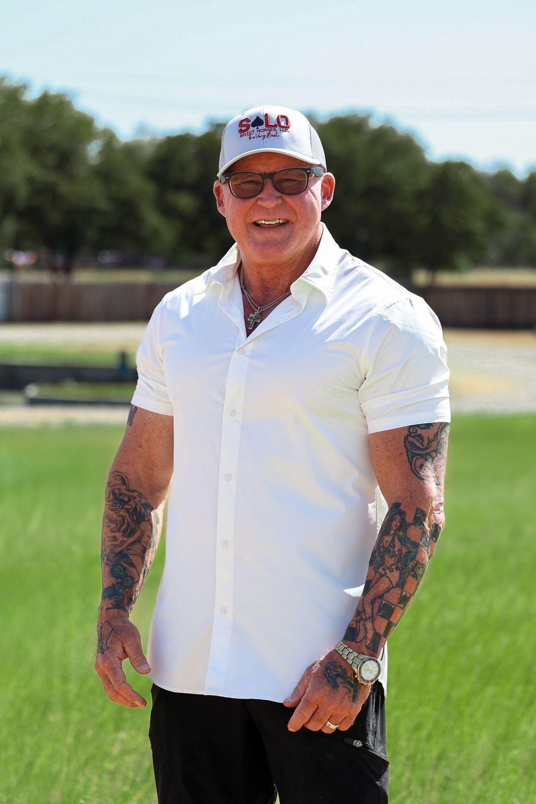 Dr. Chris Ray, DVM, MS, DACVS, the lead veterinarian at Solo Select, standing in a Solo Select cap and white shirt